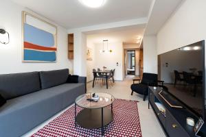a living room with a couch and a table at The Lake Break Apartamenty in Giżycko