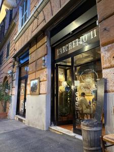 a man sitting in a chair in the window of a store at Dormire in Trastevere in Rome