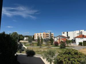 a view of a park in a city with buildings at Kozy Apartments in Međugorje