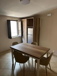 a dining room with a wooden table and chairs at Tillesia in Aiello Calabro +27 photos