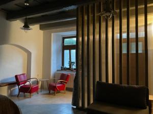 a living room with chairs and a table and a window at Historic Center Apartment in Spišské Podhradie