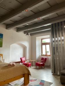 a bedroom with a bed and chairs and a table at Historic Center Apartment in Spišské Podhradie