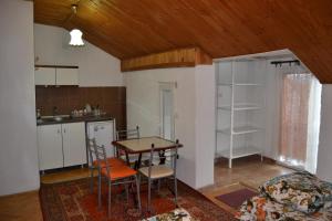 a kitchen with a table and chairs in a room at Hostel Valentin in Ohrid