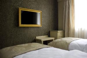 Postel nebo postele na pokoji v ubytování Neapol Boutique Hotel