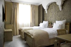 Postel nebo postele na pokoji v ubytování Neapol Boutique Hotel + 37 fotografií