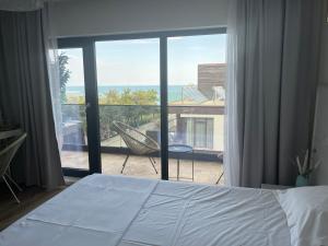 a bedroom with a bed and a view of a balcony at Vela Olimp in Olimp