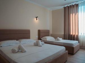 Postel nebo postele na pokoji v ubytování OKEJ Hotel