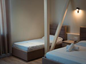 Postel nebo postele na pokoji v ubytování OKEJ Hotel