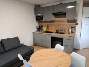 a living room with a couch and a table at Apartament Centrum in Wilkanów