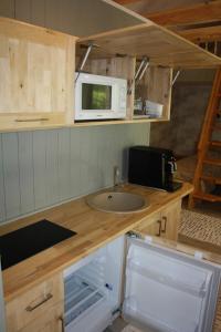 a small kitchen with a sink and a microwave at Eero Majutus in Kärdla