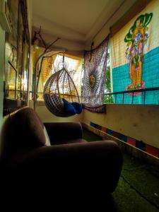 a living room with a couch and a hanging basket at The Hidden Gem Guwahati in Guwahati