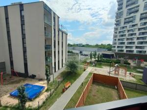 a view of a playground in front of a building at 3-Bedroom Apartment with 2 Free Parking Spots - TAURON ARENA in Kraków