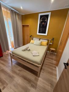 a bedroom with a bed with a picture on the wall at PRECIOUS AND ORIGINAL APARTMENT CENTER in Cádiz