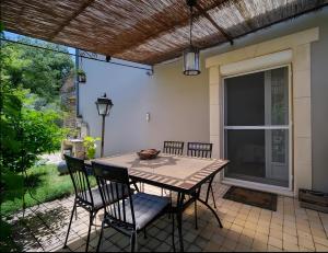 a table and chairs sitting on a patio at Gite La Bastide De La Coda in Châteauneuf-du-Rhône