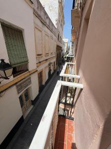 a view of an alley from a balcony of a building at PRECIOUS AND ORIGINAL APARTMENT CENTER in Cádiz