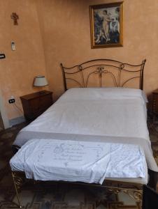 a bed with a sign on it in a bedroom at Palazzo Spiga in Quartu SantʼElena +18 photos