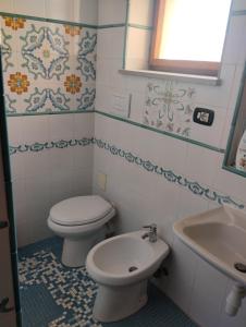 a bathroom with a toilet and a sink at Palazzo Spiga in Quartu SantʼElena