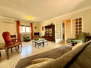a living room with a couch and a table at L'Escapade du Midi in La Celle-sous-Gouzon
