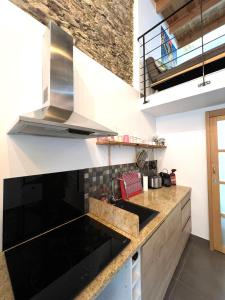 a kitchen with a sink and a stove at Maison de village in Barbaggio