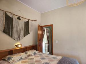 a bedroom with a bed and a window at Welcome to Sítio Arcanjos in Alto Paraíso de Goiás