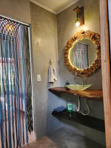 a bathroom with a sink and a mirror on the wall at Welcome to Sítio Arcanjos in Alto Paraíso de Goiás