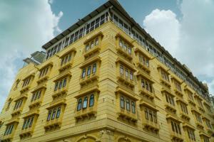 a yellow building with windows on top of it at Hotel Jaisal Inn - Pure Veg in Jaisalmer