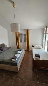 a bedroom with two beds and a lamp at Villa With Swimming Pool in Ulcinj