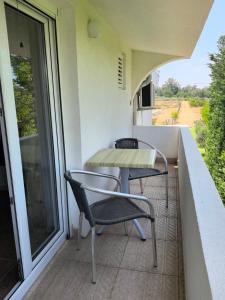 a balcony with a table and chairs on it at Villa With Swimming Pool in Ulcinj +15 photos