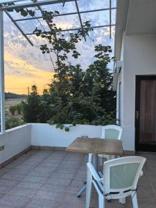 a patio with a wooden table and chairs on a balcony at Villa With Swimming Pool in Ulcinj