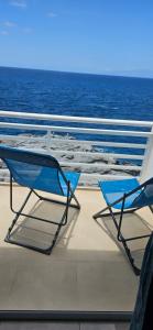 two blue chairs sitting on the deck of a boat at Aquarius Loft in Callao Salvaje