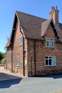 a brick house with a roof on a street at Flo's Cottage self-catering in Newark-on-Trent +12 photos