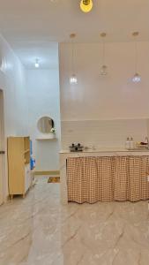 a kitchen with a table in the middle of a room at DM Guesthouse - Impasugong Bukidnon in Impasugong +9 photos