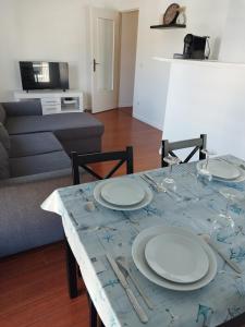 a table with plates on it in a living room at Beautiful 2-room apartment - Meaux - near Disneyland in Meaux