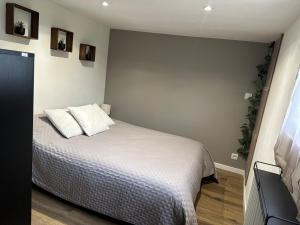 a bedroom with a bed with two pillows on it at Maison Familiale Gers 12 pers in Fleurance +42 photos