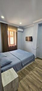 a bedroom with a large bed and a window at OUR House in Vagharshapat