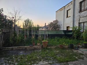 a garden with potted plants and a fence at Garden guest house in Tirana