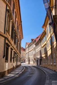 an empty street in an old town with buildings at Nový pokoj u Pražského výstaviště A3 in Prague