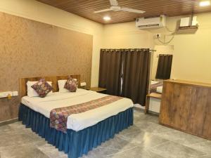 a bedroom with a large bed in a room at Raghunandan Resort Cottages in Nashik