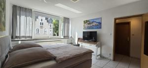 a bedroom with a large bed and a window at Vacation and business city apartment in Mönchengladbach