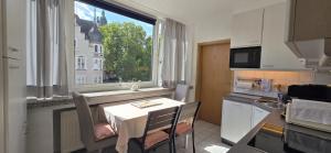 a small kitchen with a table and a window at Vacation and business city apartment in Mönchengladbach