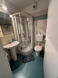 a bathroom with a shower and a toilet and a sink at Marina View Apartment Izola in Izola