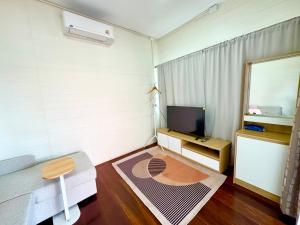 a living room with a couch and a television at DD Canel in Bangkok