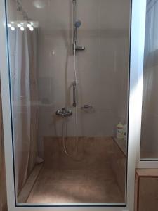 a shower in a bathroom with a glass door at Villa Eleni in Kypséli