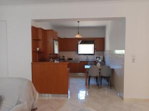 a kitchen and dining room with a table and chairs at Villa Eleni in Kypséli