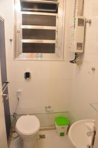 a small bathroom with a toilet and a sink at No Coração de COPACABANA in Rio de Janeiro