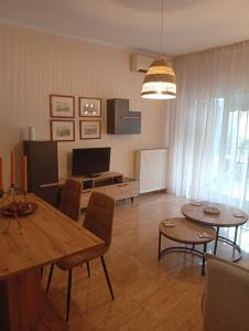 a living room with a table and a dining room at ChroMa View in Kavala