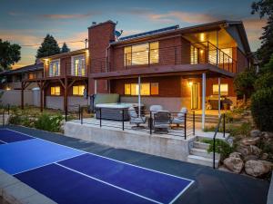 a house with a tennis court in front of it at All-New Luxe Stay Views, Sauna & Hot Tub villa in Holladay
