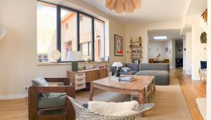 a living room with a couch and a table at Large house, very high standing in Bordeaux
