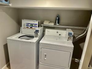 a small laundry room with a washer and dryer at Beautiful Home Near Downtwon - Free Parking! in Chicago