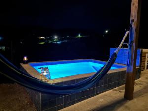 a hammock around a swimming pool at night at The Hangover Block in Culebra